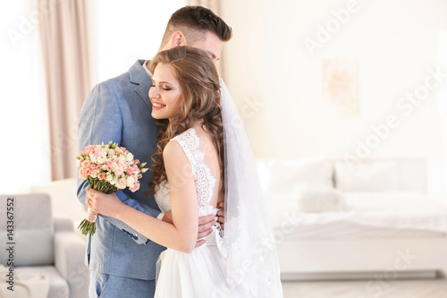 Happy wedding couple at home