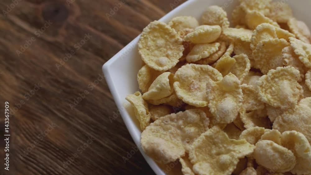 Corn flakes in white bowl with copyspace to the left. Slide right Corn flakes in white bowl with copyspace to the left. Slide right