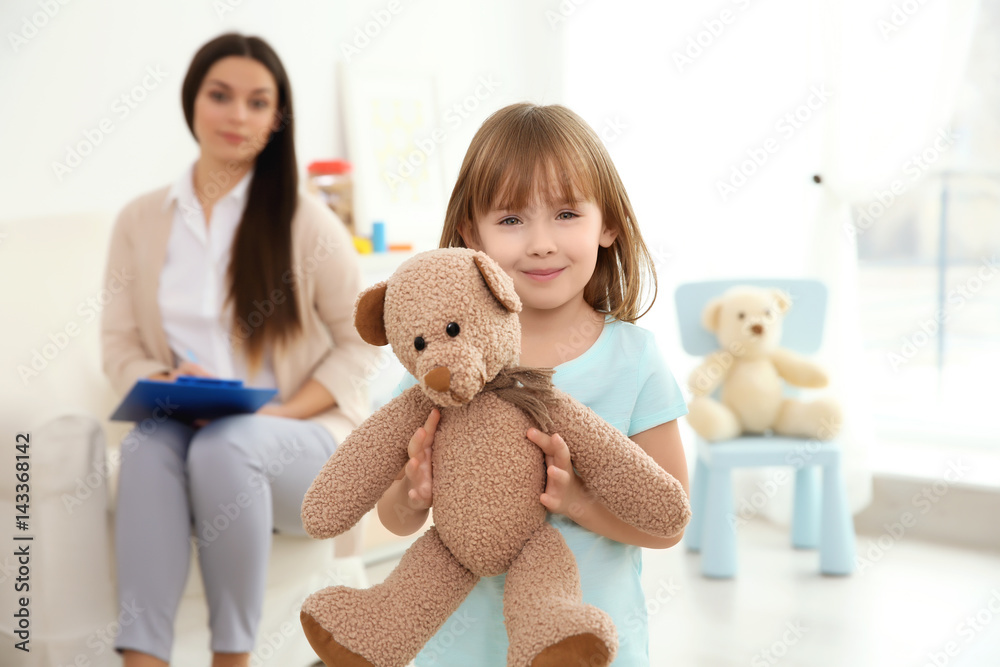 Little girl with teddy bear and child psychologist on background Stock ...