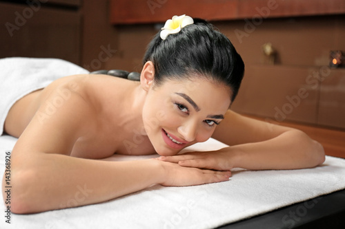 Beautiful young woman in spa salon