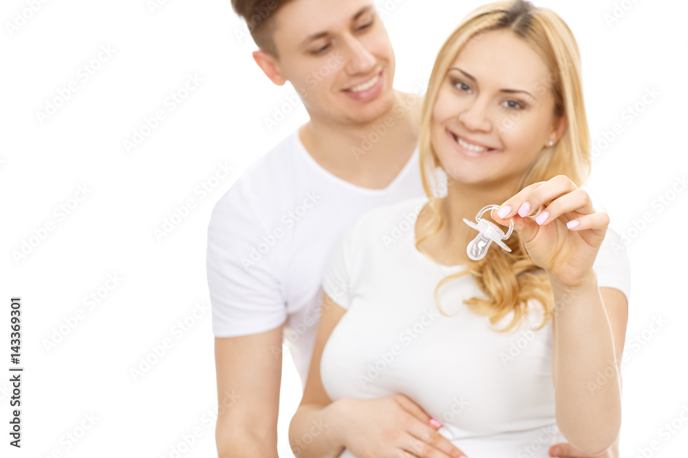 Pregnant woman and her husband with baby accessories Pregnant woman and her husband with baby accessories