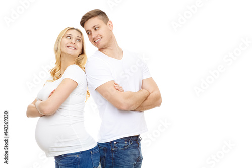 Young pregnant happy woman posing with her handsome husband