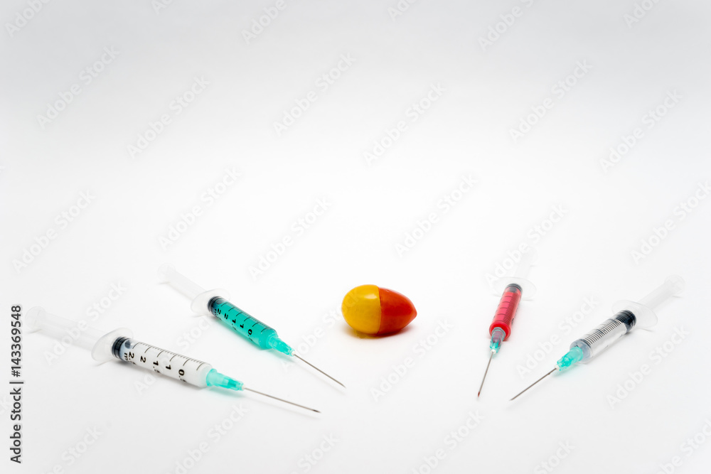 GMO concept on white background with syringes and tomato. GMO concept on white background with syringes and tomato.