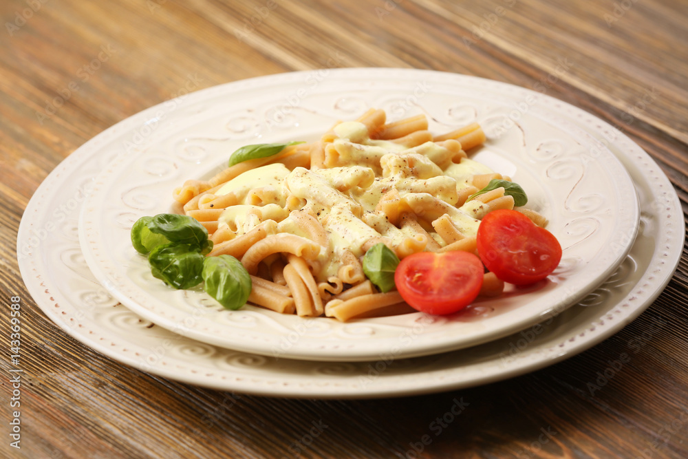Portion of delicious pasta with cheese on wooden background Portion of delicious pasta with cheese on wooden background