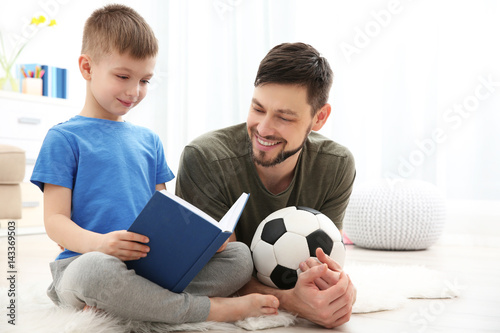 Father and son reading book...