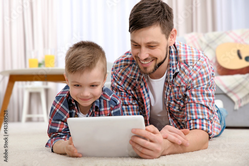 Father and his son with tab...