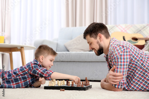 Father and son playing ches...