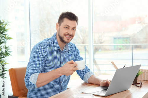 Handsome young man working ...