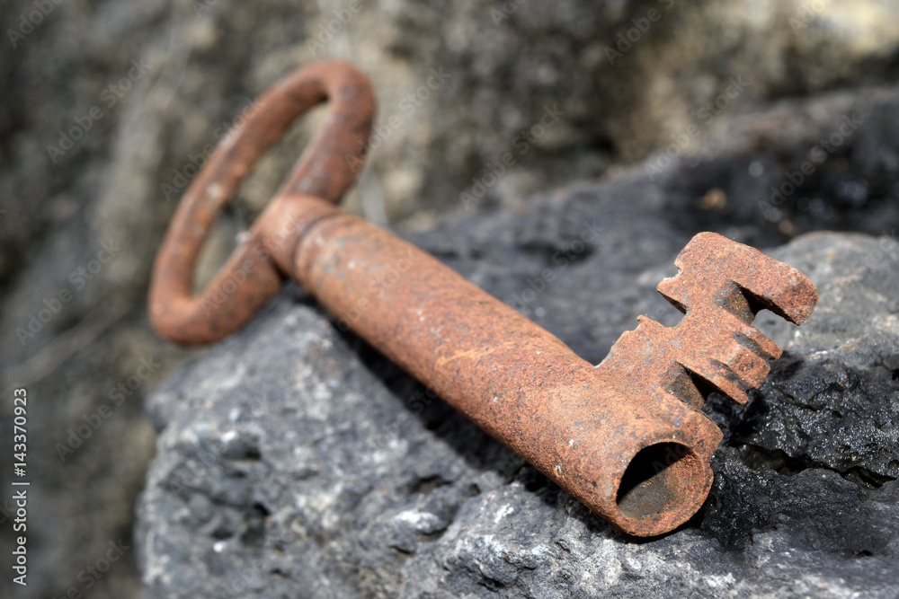 very old door key in rusty iron