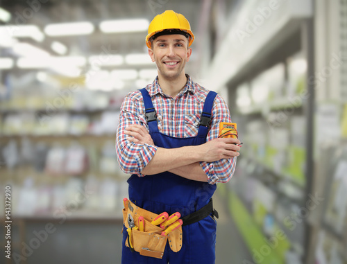 Young electrician with tool...