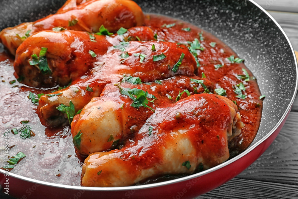 Frying pan with chicken cacciatore, closeup Frying pan with chicken cacciatore, closeup