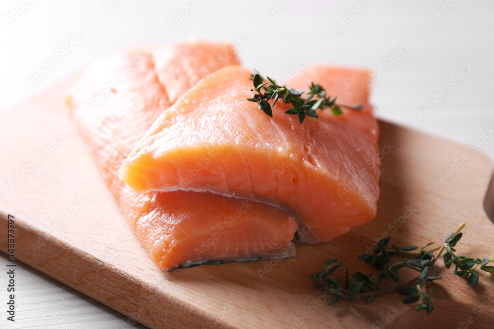 Fresh salmon fillet on wooden cutting board