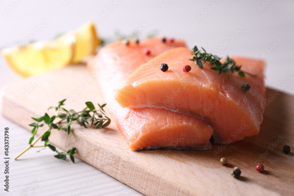 Peppered salmon fillet on wooden cutting board Peppered salmon fillet on wooden cutting board