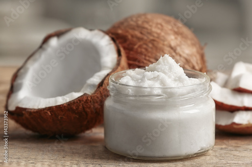 Fresh coconut oil in glass jar on wooden table
