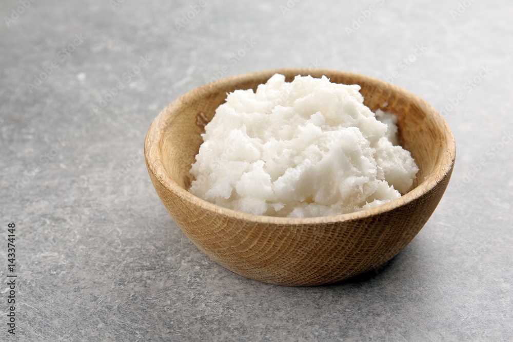 Wooden bowl with fresh coconut oil on table Wooden bowl with fresh coconut oil on table