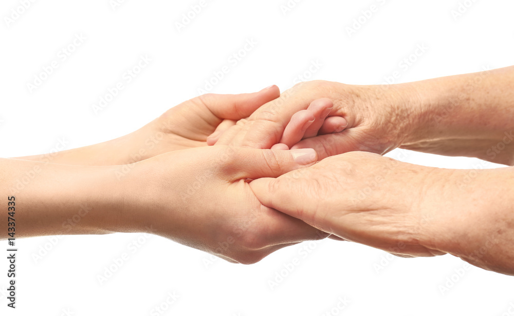 Old and young women holding hands on white background, closeup