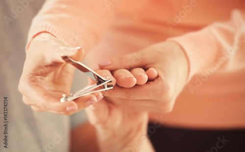 Woman manicuring hands of elderly patient, closeup
