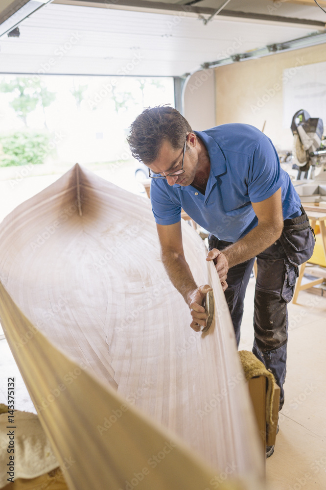 Sweden, Man building wooden rowboat Sweden, Man building wooden rowboat
