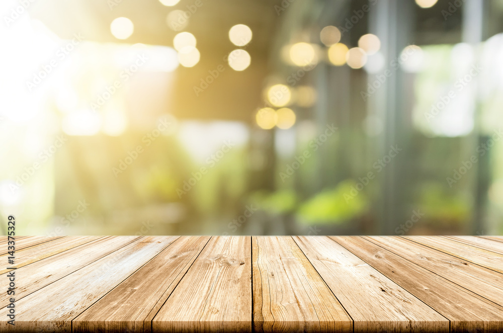 Empty light wood table top with blurred in coffee shop background - obrazy, fototapety, plakaty 