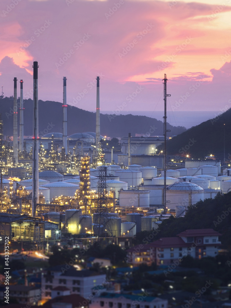 A large oil refinery Near the community As the early evening light, or light Twilight.