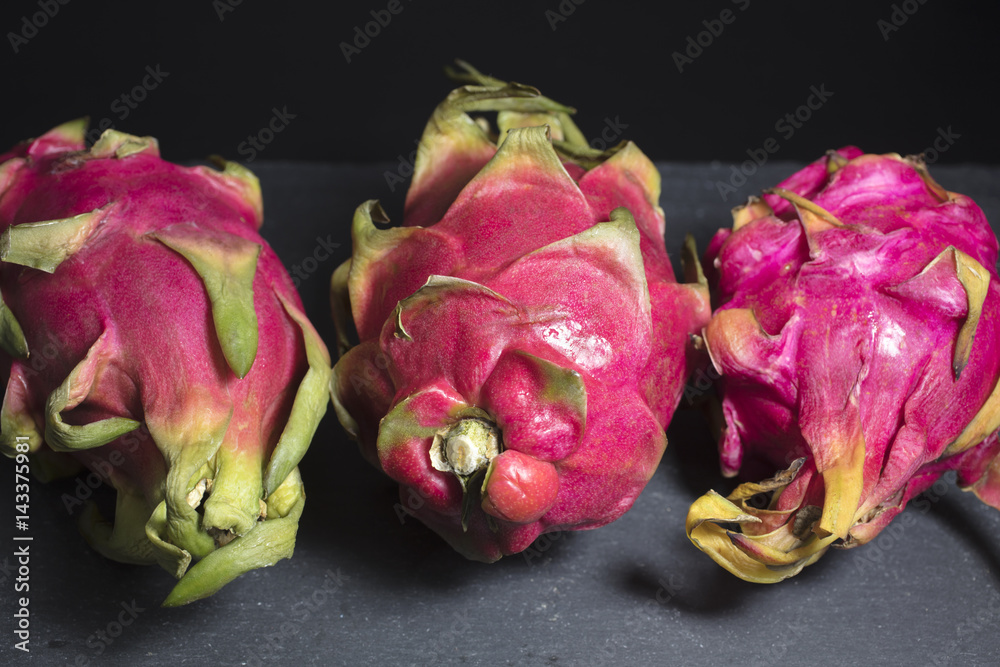 Three Dragon Fruits on a Cutting Board Three Dragon Fruits on a Cutting Board