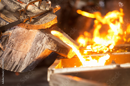 perator pouring molten metal in automatic casting line in foundry factory