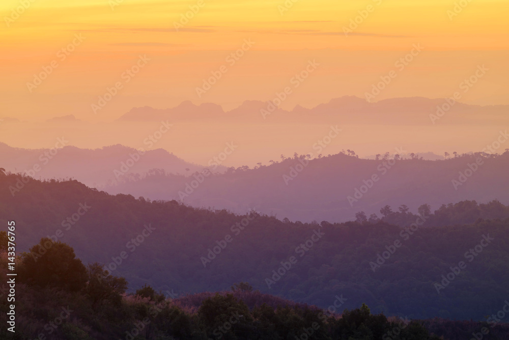 high view sunrise in early morning over  rainforest mountain in thailand 