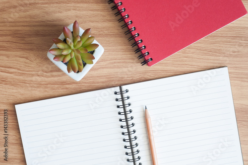 open spiral notebook with a pencil on the desk © piggu