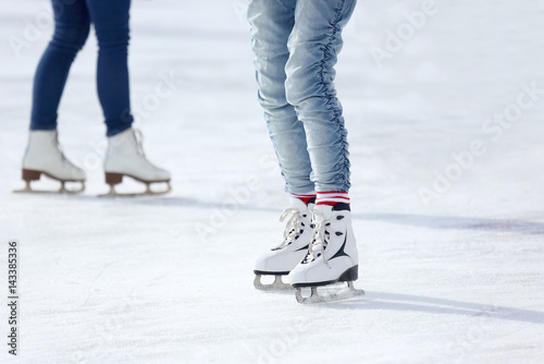 feet skating on the ice rink
