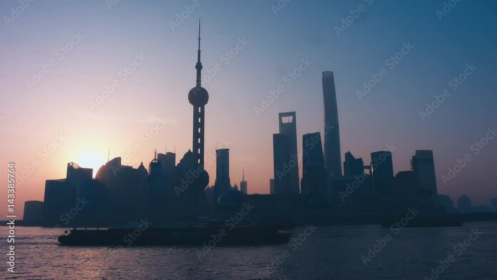 Sun in showing from behind the building in Shanghai central business district. Morning shot, sunrise. 4K UHD Sun in showing from behind the building in Shanghai central business district. Morning shot, sunrise. 4K UHD