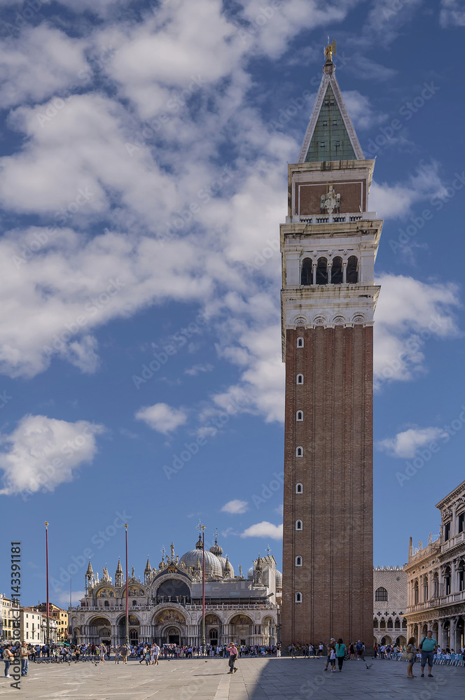 Beautiful vertical view of Piazza San Marco square in a moment of tranquility on a sunny summer day, with a picturesque sky, Venice, Italy