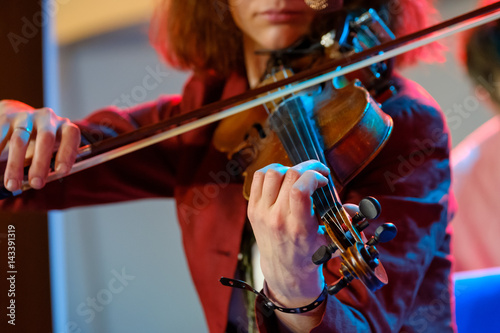 Young woman playing the violin close up