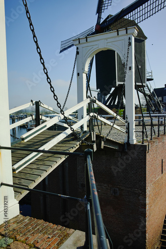 Small river harbor, drawbrige and windmill in Heusden - old village in Brabant photo