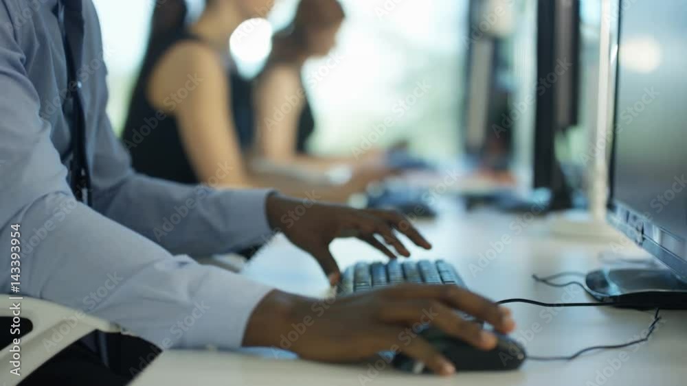  Close up on hands of unrecognizable worker working on computer in city office