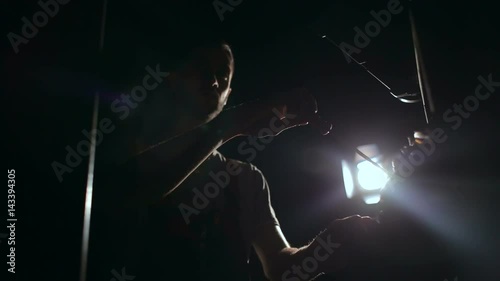 Silhouette of a man with a screwdriver. Repair of lighting equipment. photo