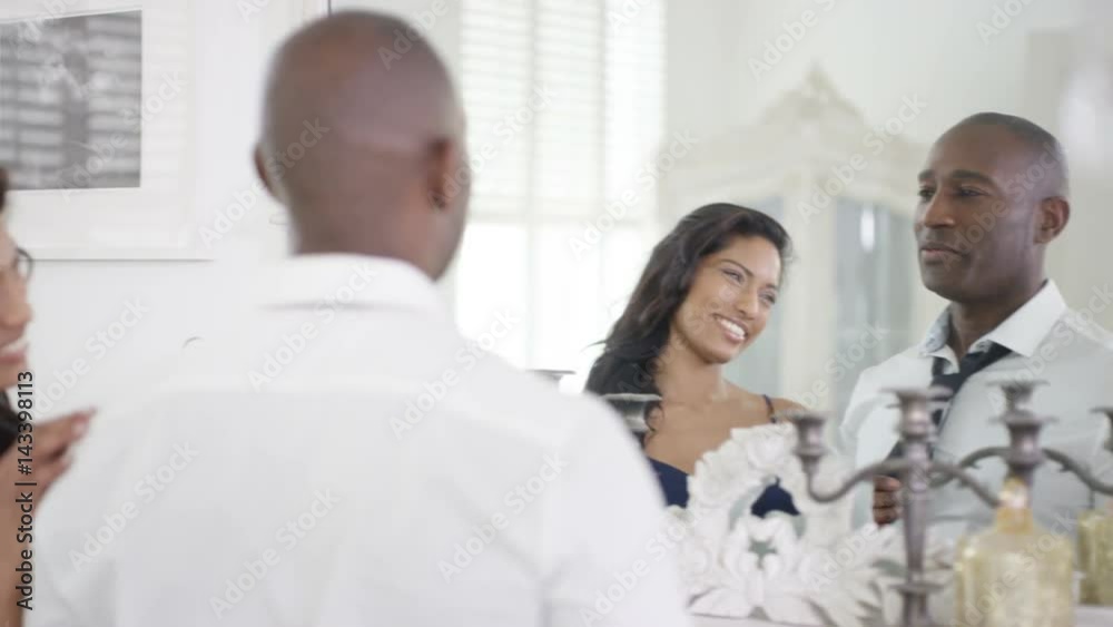 Affectionate couple in apartment getting ready to go out Affectionate couple in apartment getting ready to go out
