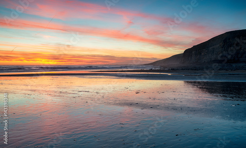 Fototapeta Naklejka Na Ścianę i Meble -  Sunset over the beach at Dunraven Bay