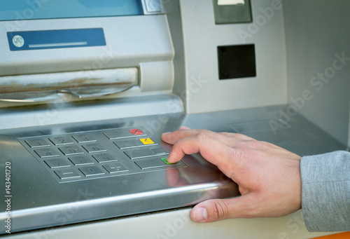 young man hand bush accept button on atm