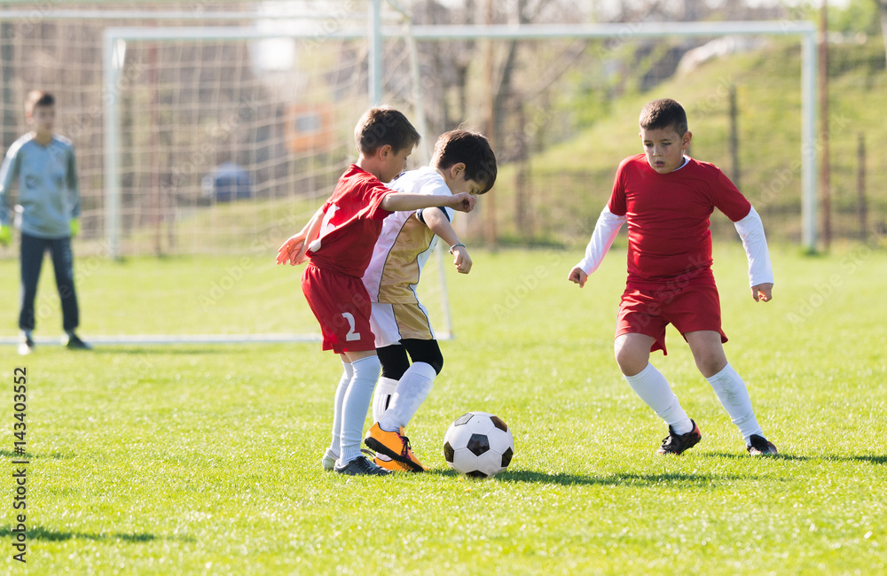 Kids soccer football - children players match on soccer field Kids soccer football - children players match on soccer field