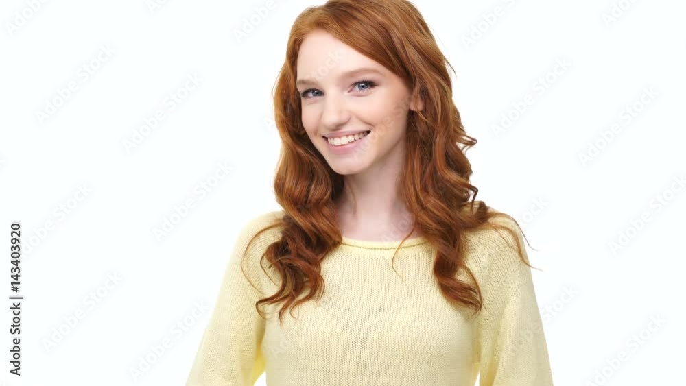 Happy positive smiling young redhead woman with thumbs up gesture over white background Happy positive smiling young redhead woman with thumbs up gesture over white background