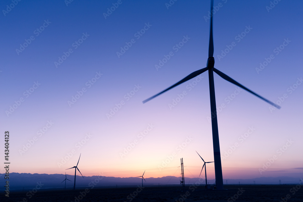 Fototapeta premium wind turbines in field at twilight