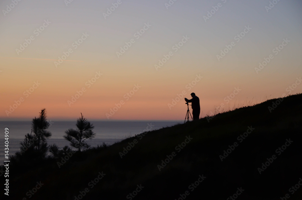 Photographer photographing the sunset,Vizcaya,Basque Country