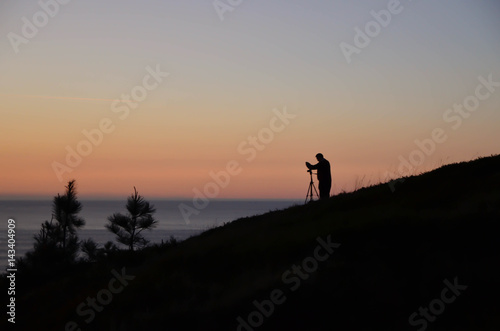 Photographer photographing the sunset,Vizcaya,Basque Country