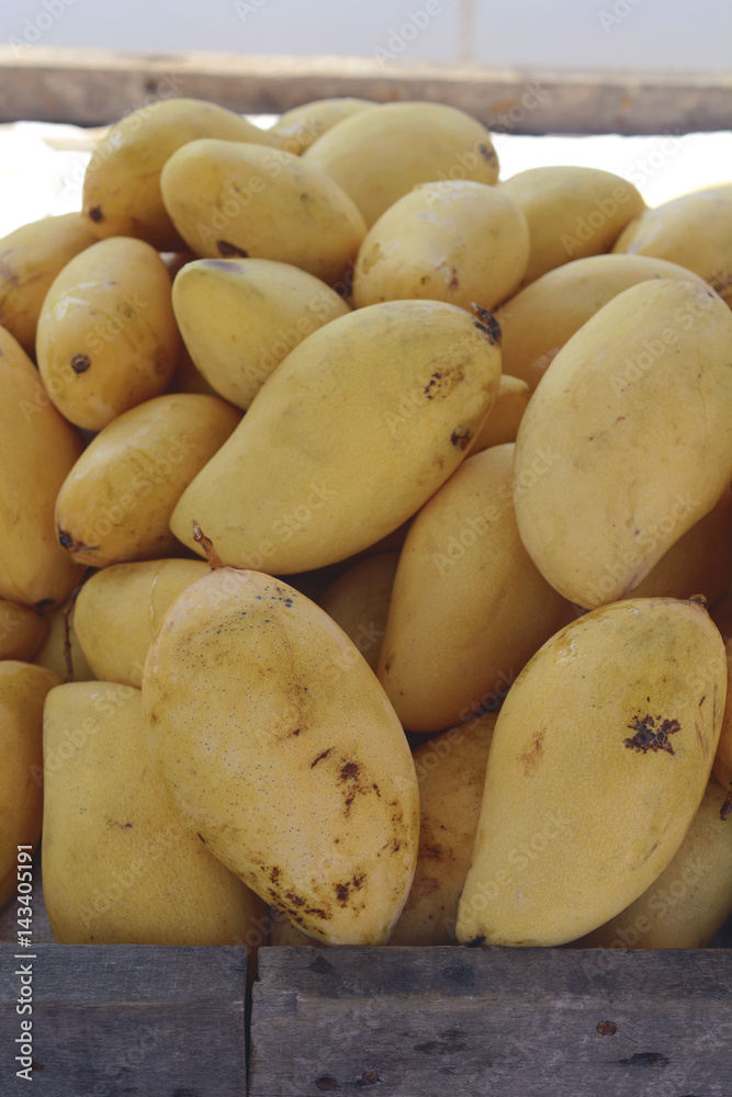 pile of fresh mango fruits in street market. pile of fresh mango fruits in street market.