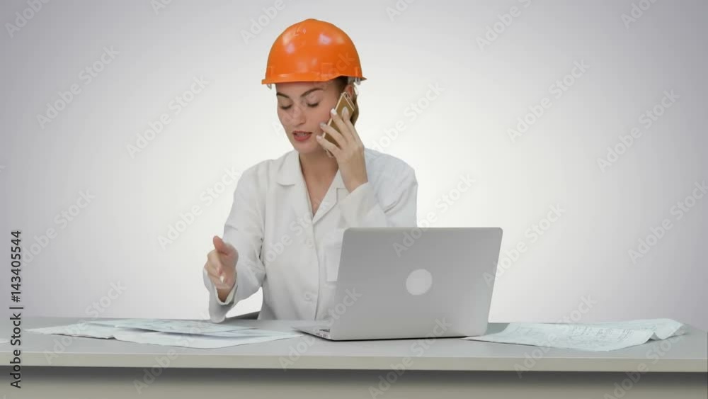 Woman in orange hardhat calling the phone discussing constraction plan on white background. Woman in orange hardhat calling the phone discussing constraction plan on white background.