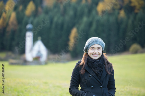 Asian people stand posing front of small church