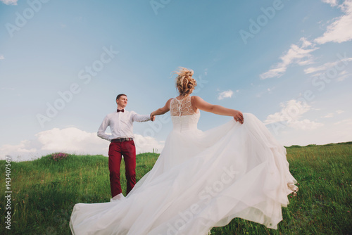 Happy and young bride and groom dancing on nature, dance pose on wedding day,wedding dance in the open air. Dancers love flying.