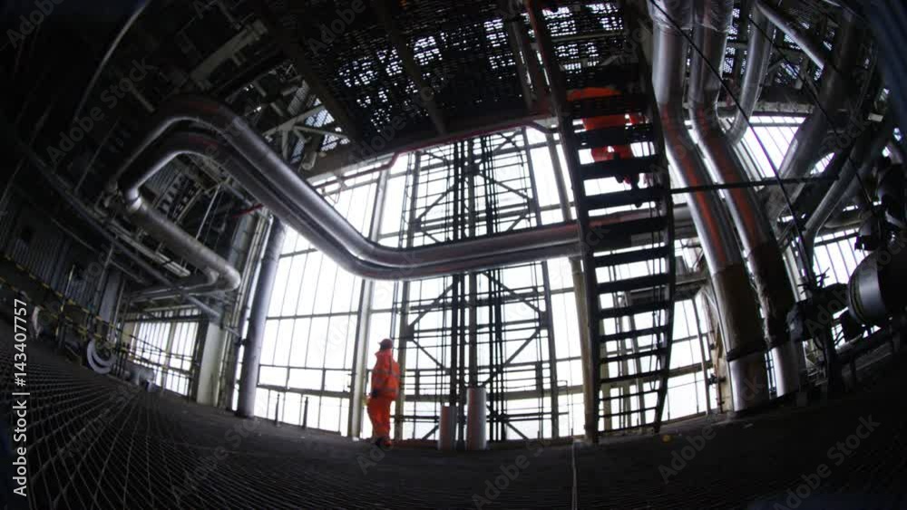 Distorted view of engineers at work in industrial plant Distorted view of engineers at work in industrial plant