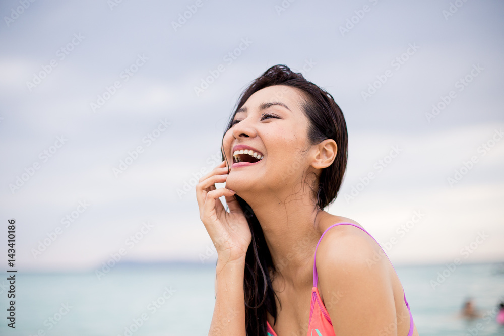 Pretty girl laughing to the sun on the beach Pretty girl laughing to the sun on the beach
