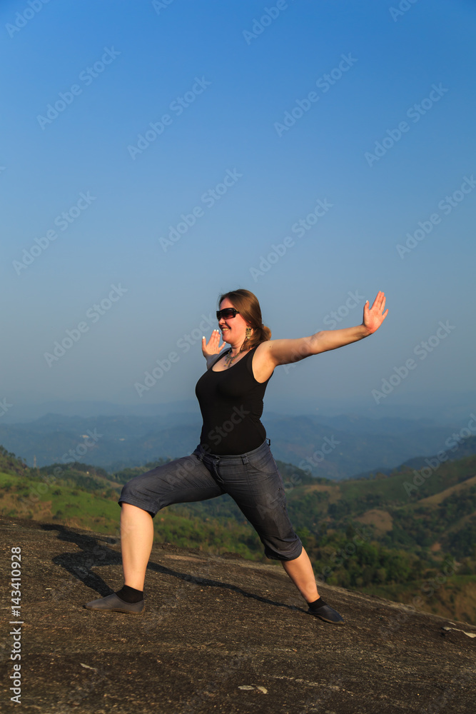 Woman practicing yoga outdoors. Woman practicing yoga outdoors.